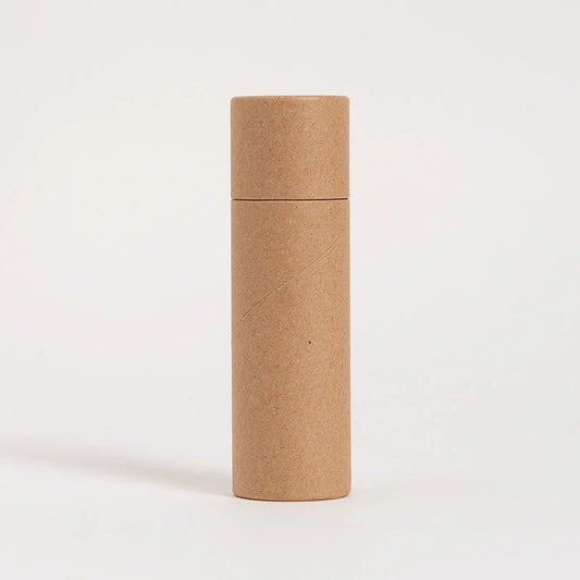 A tall, cylindrical, brown paper tube stands against a white background, exemplifying eco-friendly packaging with its simple, unadorned, and recyclable material design.