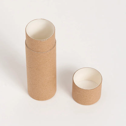 An upright brown paper tube with its white-lined lid placed to the side, all set against a white background, highlighting a natural, eco-conscious packaging solution.