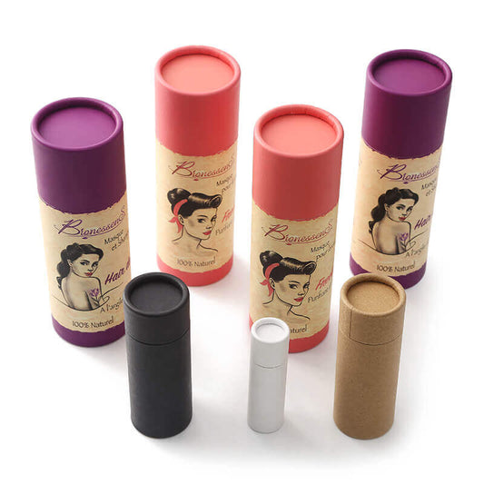 A collection of colorful paper tubes with caps in various sizes and hues, some featuring vintage-style illustrations, arrayed on a white surface.