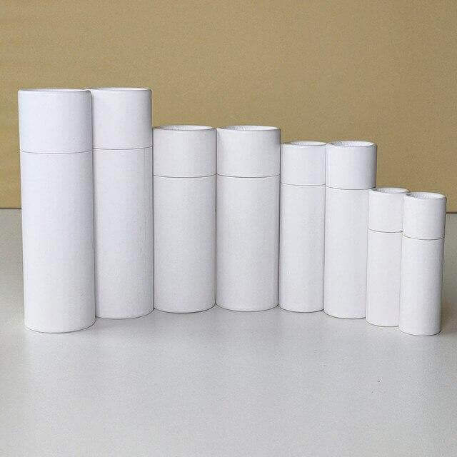 white cylindrical cardboard containers organized by height 