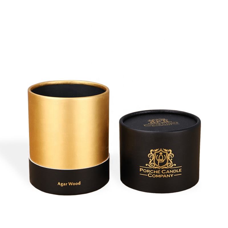 An open cylindrical container featuring a sleek black exterior with gold trim and a luxurious gold interior, suggesting a high-end product presentation, isolated on a white background.