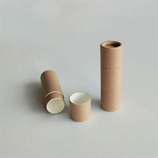 Two brown cylindrical containers standing upright with one lying horizontally open, showing a light interior, on a grey background.