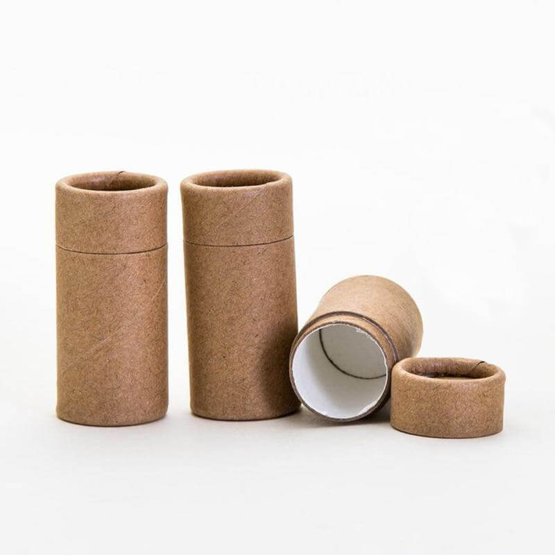 Brown paper tubes in various sizes, some standing and one tipped over, on a white background.