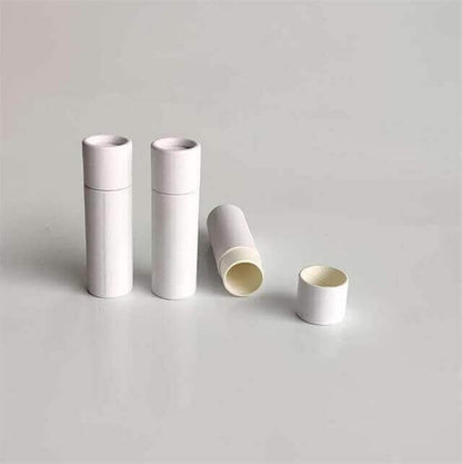 Two closed white paper tubes stand upright beside one lying open with a cap off, on a light grey background.