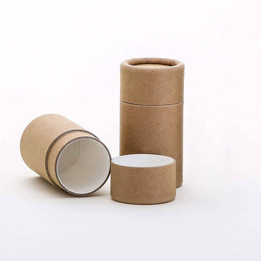 Two eco-friendly brown kraft paper tubes with one standing upright and the other lying open beside it, showcasing a white interior, on a plain white background.
